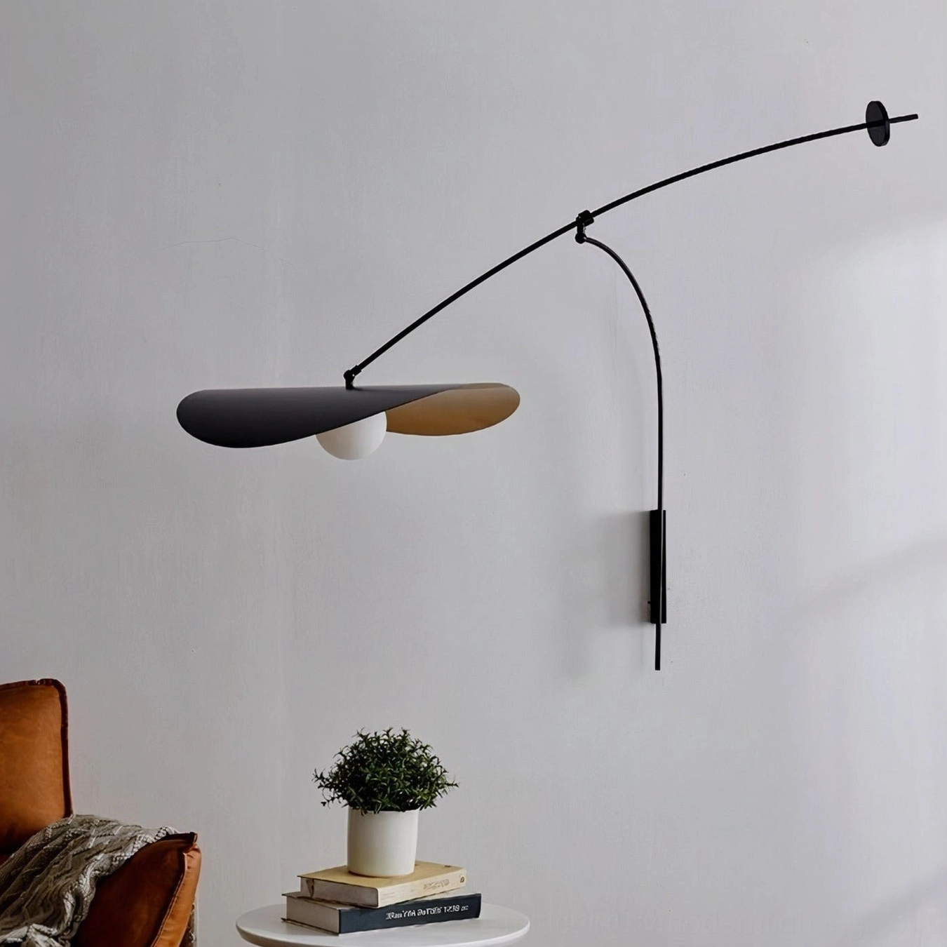 Myrna arc wall lamp in minimalist display area, matte black metal sculpture, side view