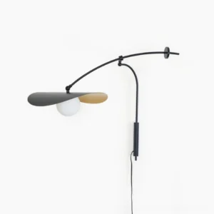 Myrna mid-century modern plug-in wall lamp, sculptural black and gold metal design, front view on white background