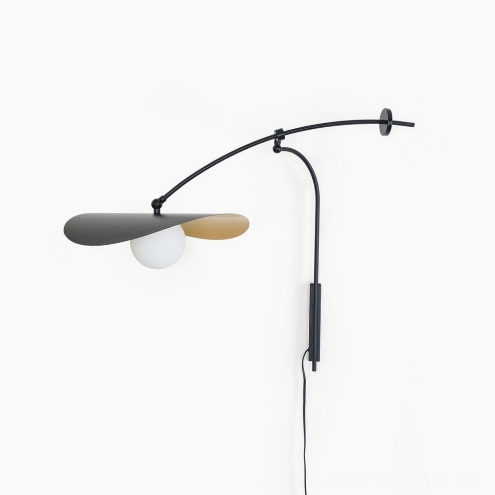 Myrna mid-century modern plug-in wall lamp, sculptural black and gold metal design, front view on white background