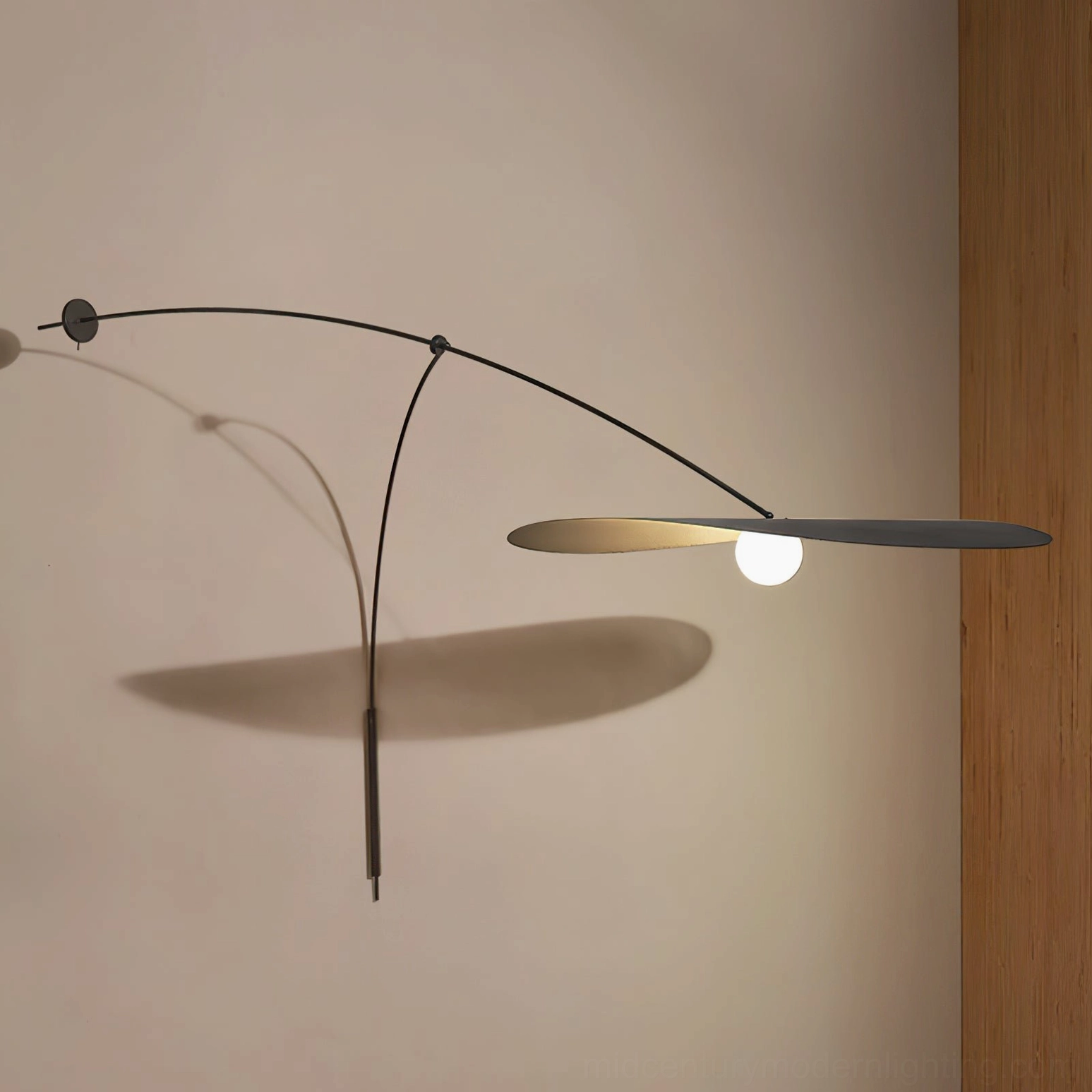 Myrna wall lamp side profile showing curved arm, minimalist metal silhouette design