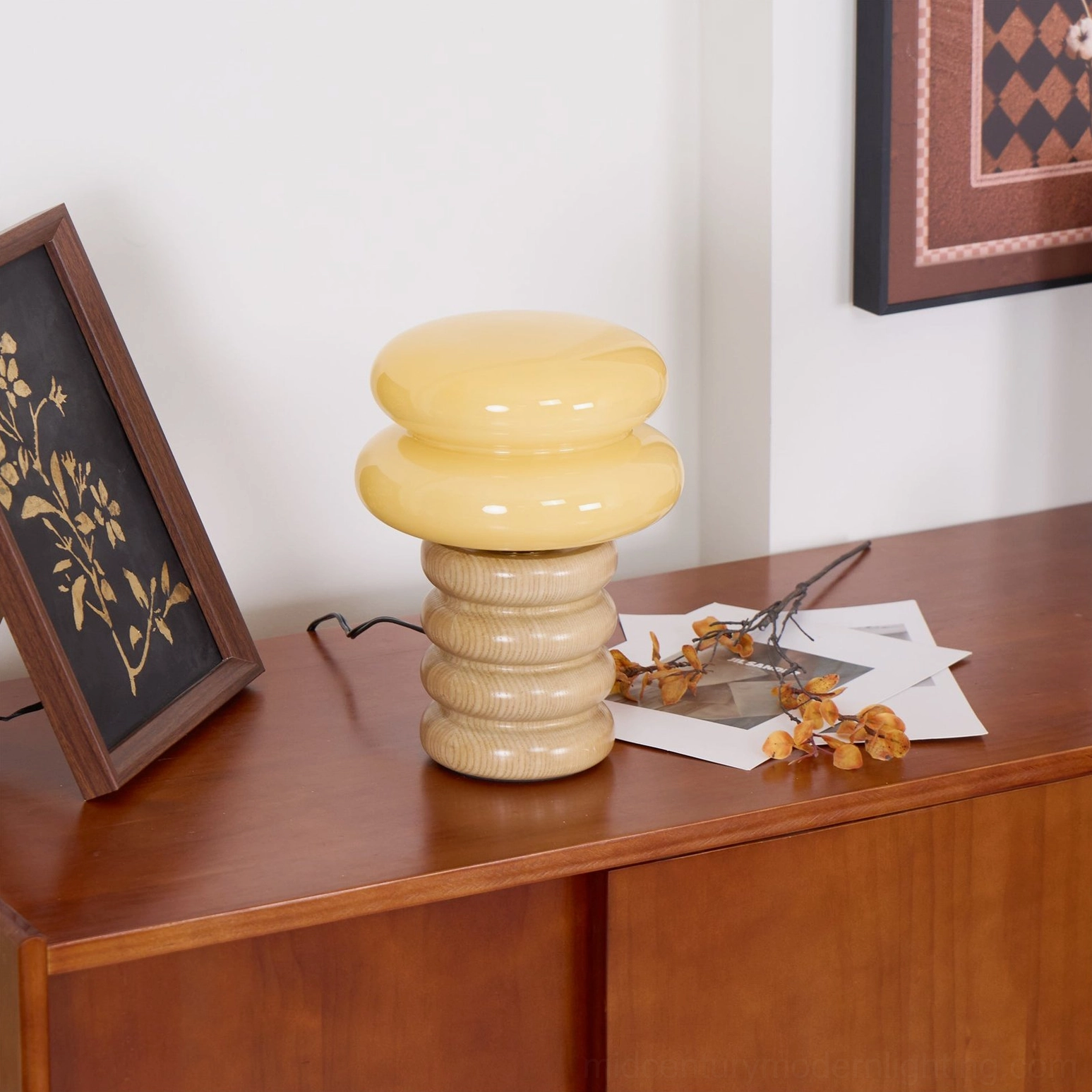 Compact Napako table lamp with hand-spliced wood base positioned on console table surrounded by stationery and warm neutral decor