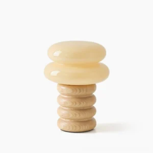 Napako mid-century modern table lamp with stacked ash wood base and frosted glass shade in minimalist white studio setting