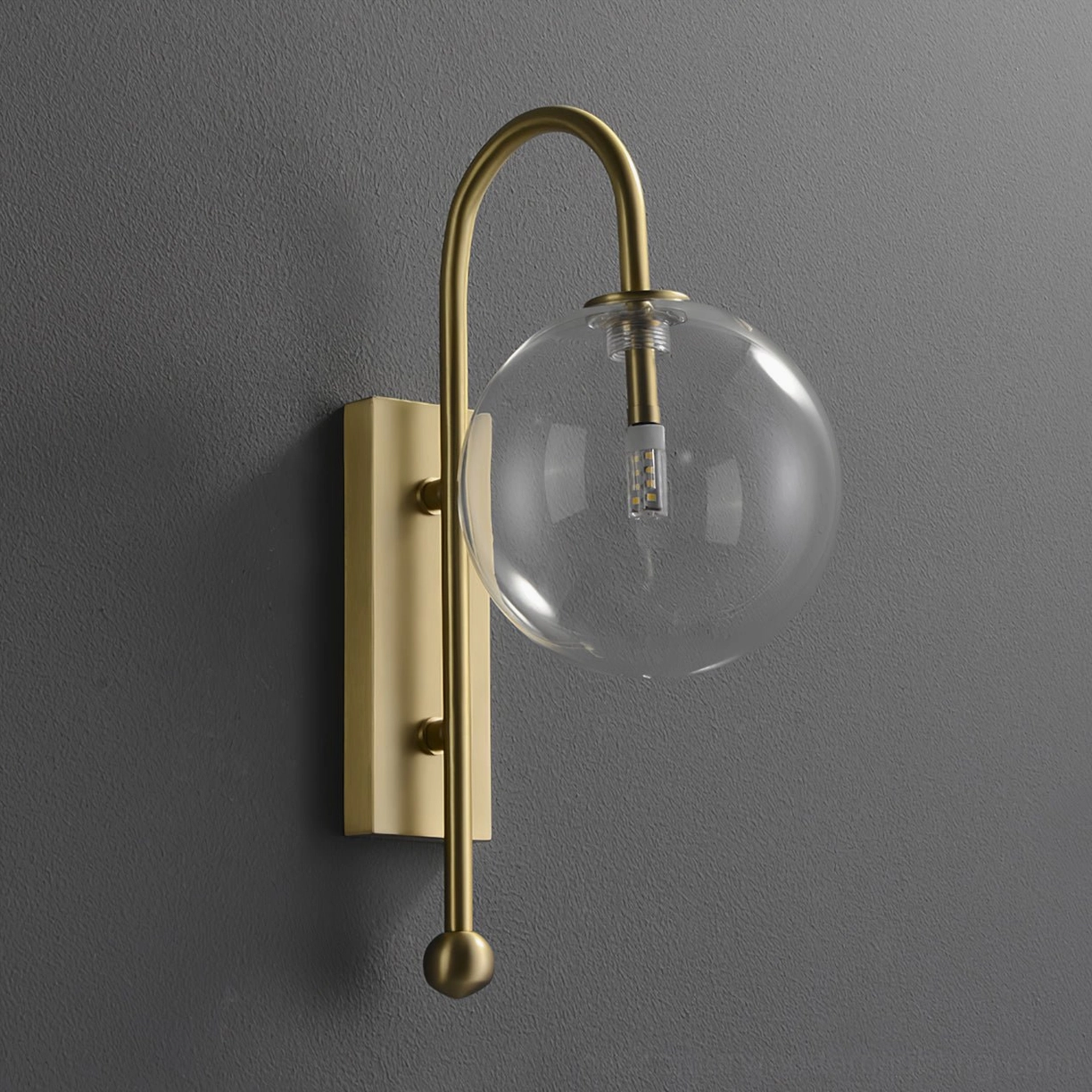 Warm brass-toned metal spherical glass wall lamp in contemporary minimalist style