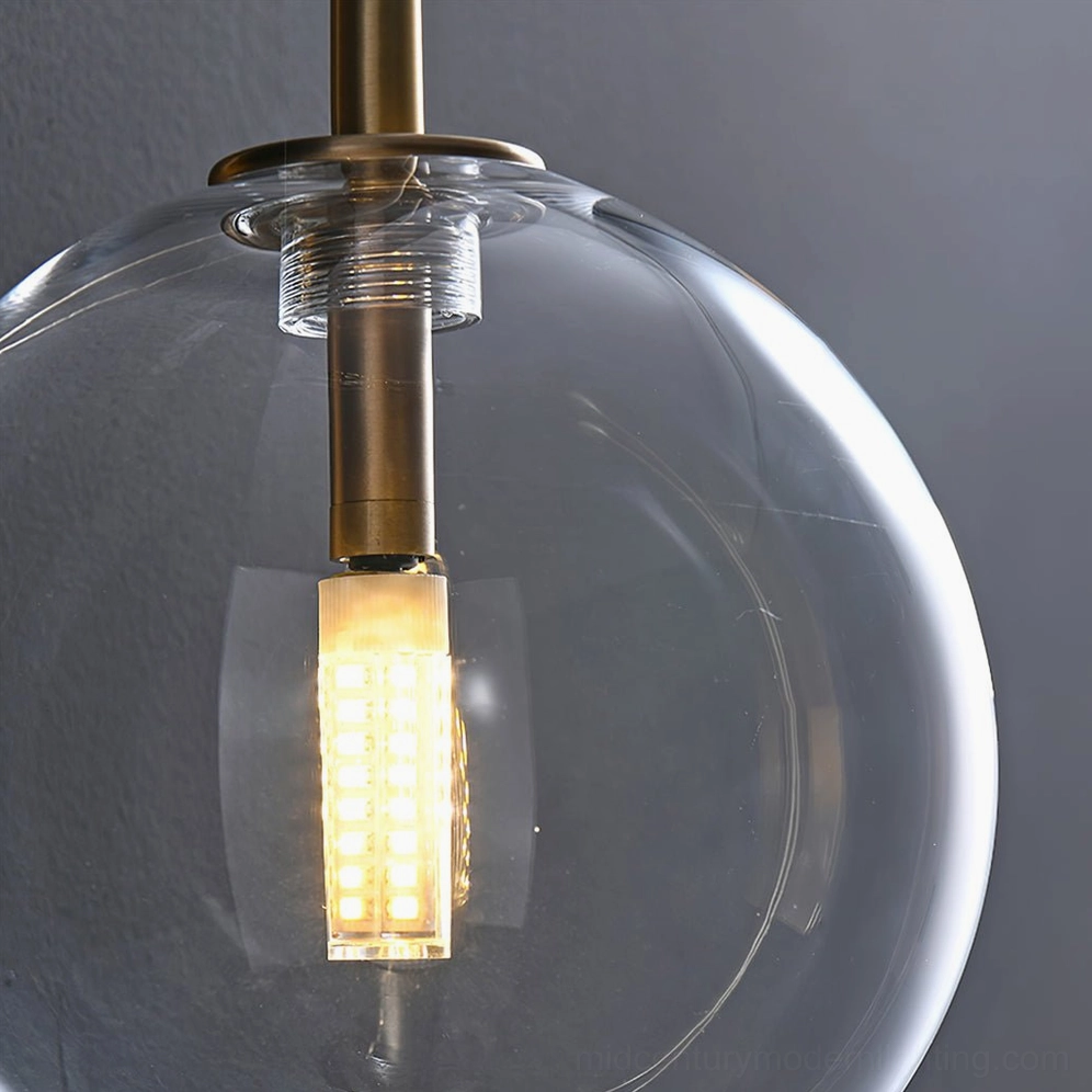 Copper metal framework supporting clear glass globe wall-mounted sconce fixture