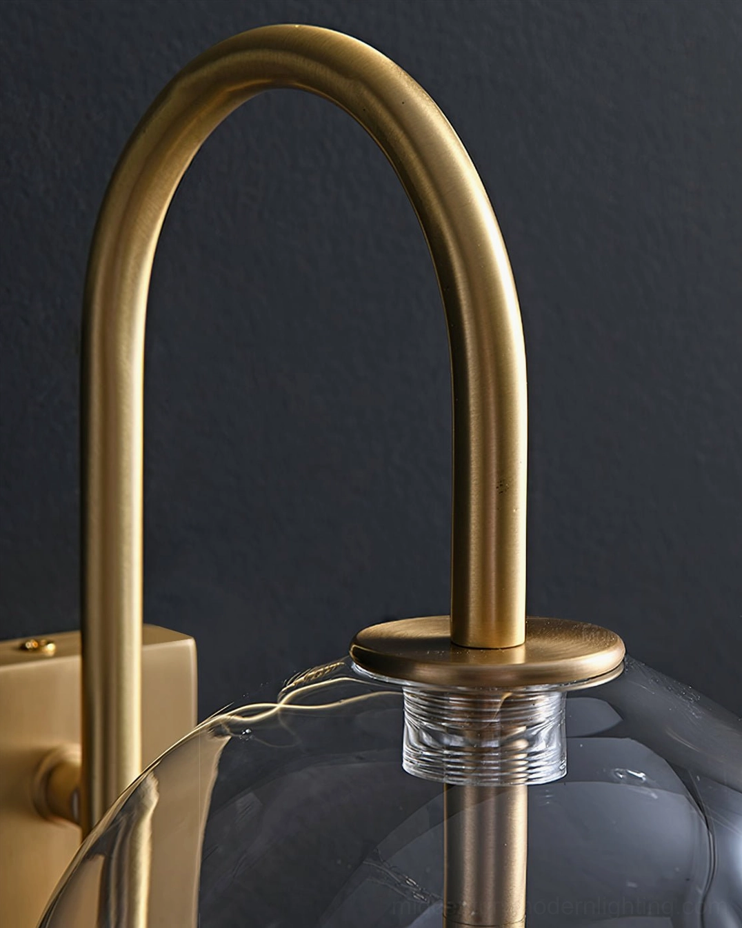 Refined metal framework and clear glass globe Naples wall sconce architectural detail