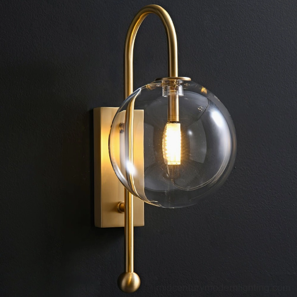 Spherical clear glass shade mounted on copper metal arm modern wall sconce side angle