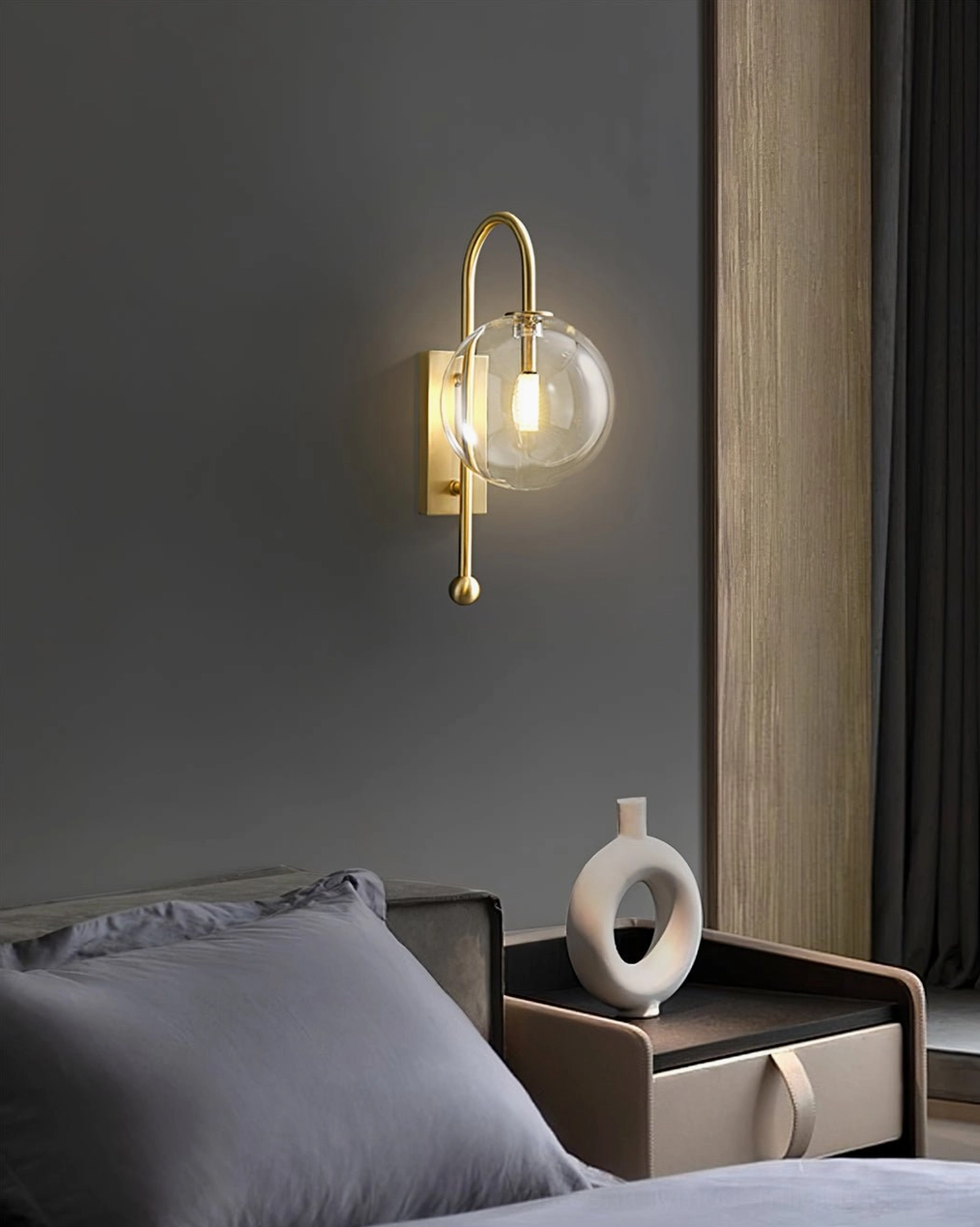 Bedroom wall sconce mounted beside nightstand and decorative elements on master bedroom wall