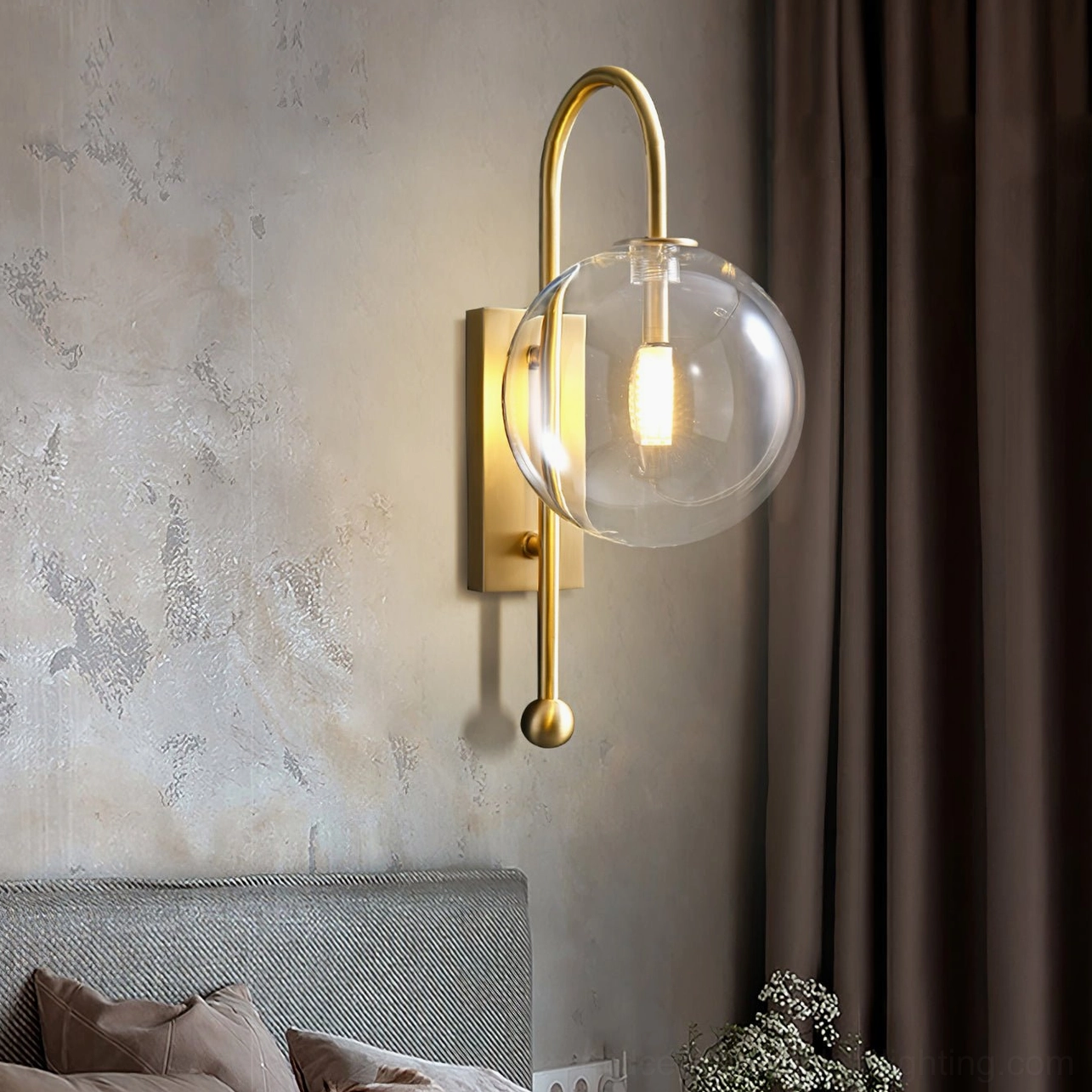 Copper glass globe wall lamp mounted on grey bedroom wall beside bed creating warm bedside lighting