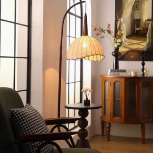 Naumy floor lamp in French vintage living room setting with glowing warm light, paired with green armchair and wooden cabinet