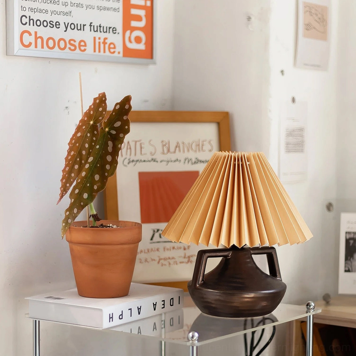 Navia pleated lamp displayed in boho minimalist studio with potted plant and wall art