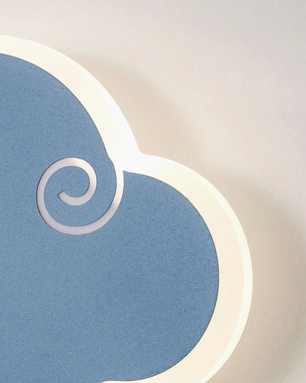 Navy blue cloud wall lamp with matte finish and white decorative swirl details extreme close-up