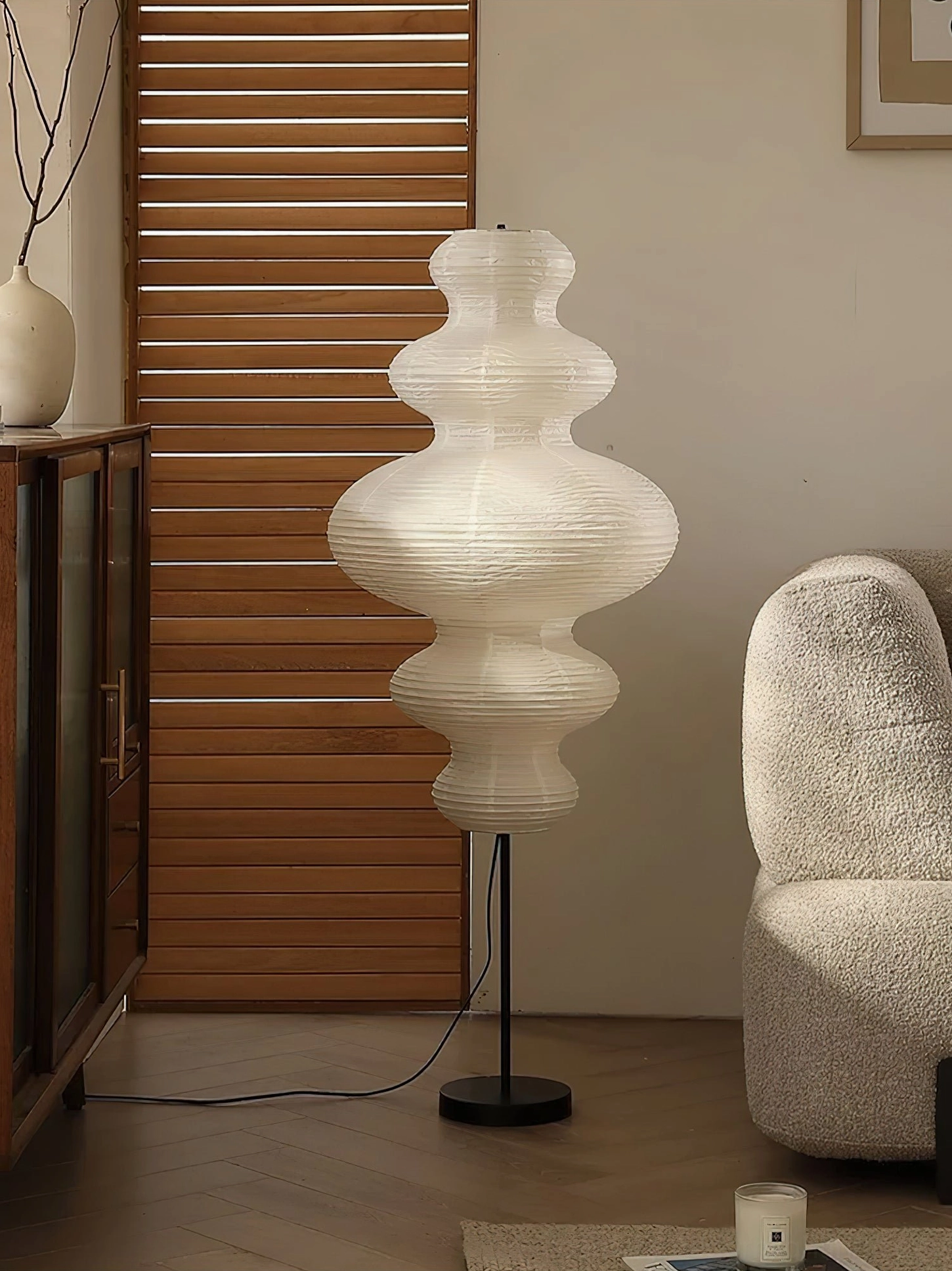 Eye-level view of Neiko paper floor lamp in vintage living room setting with wooden cabinet and louver backdrop