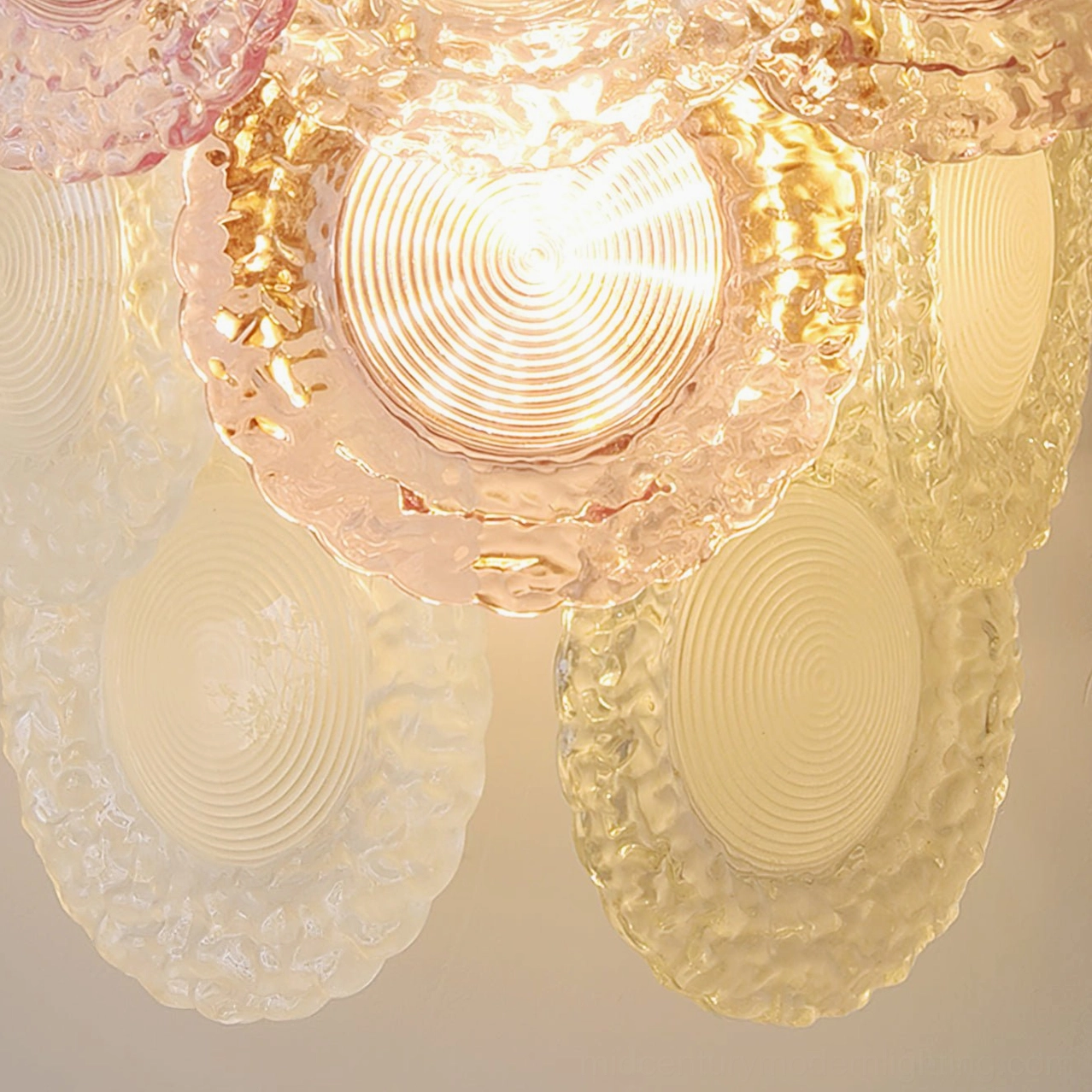 Nenufar wall lamp glass shade detail with transparent colored ripple texture and warm interior glow
