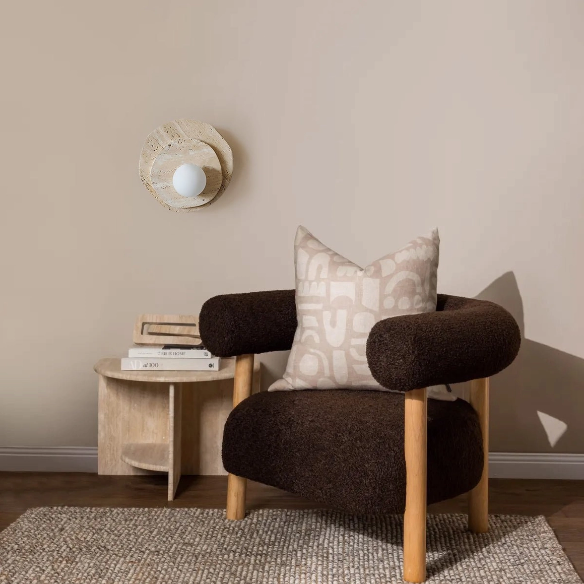 Ner natural travertine wall light mounted in contemporary interior space, warm cohesive neutral home design context
