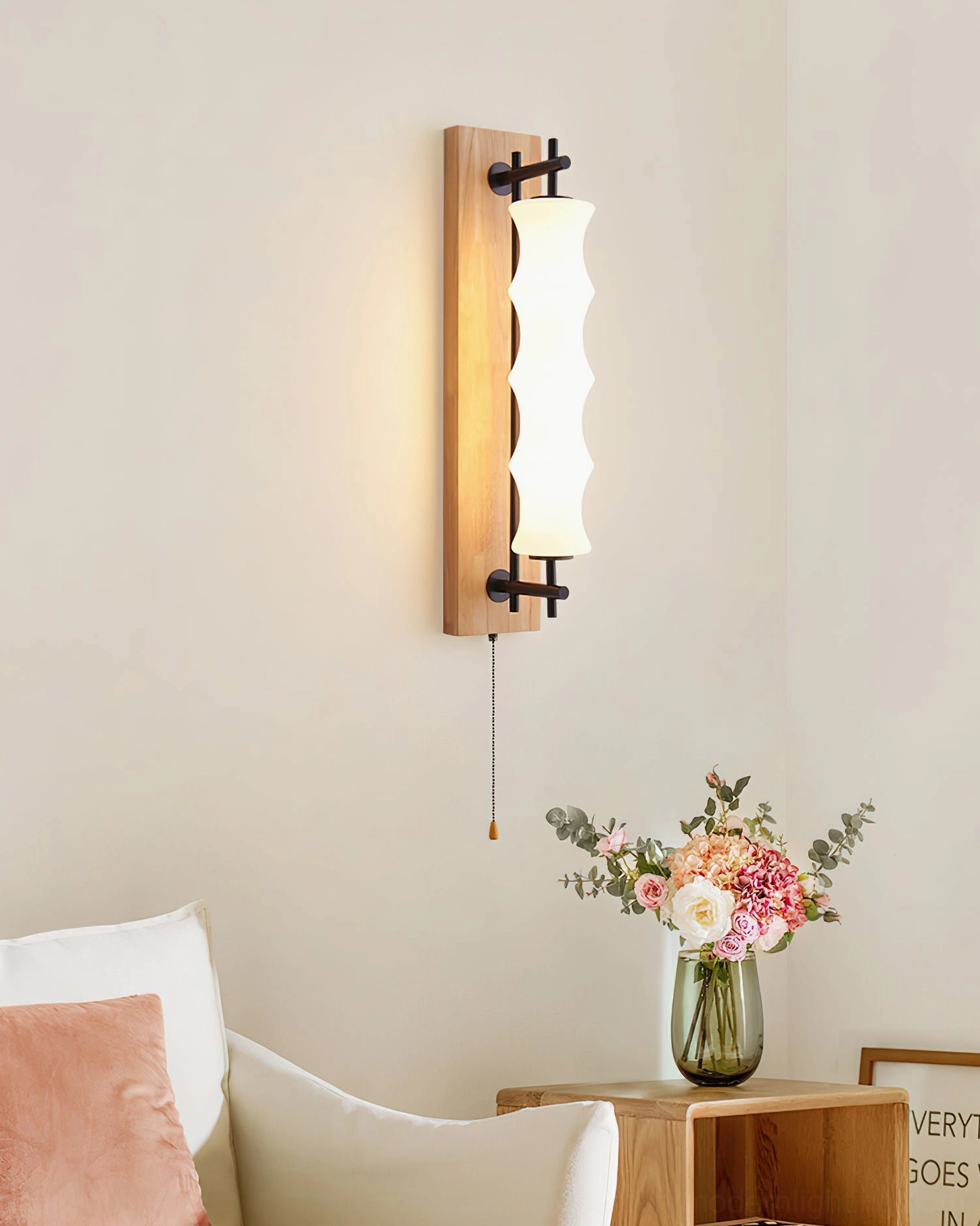 Nesta gooseneck sconce in living room with light wood finish, styled near sofa and side table with vase