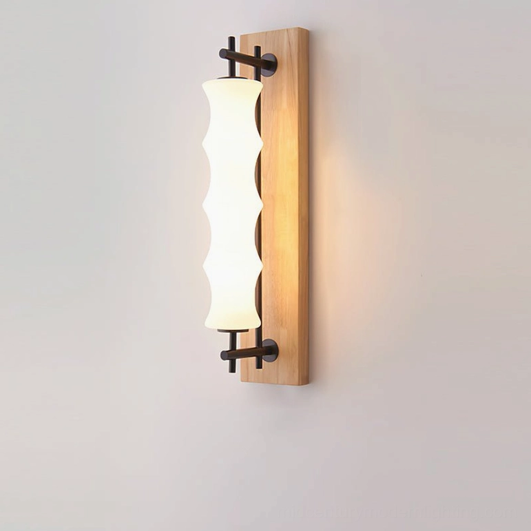 Nesta mid-century modern wall sconce with wood finish, angled view showing rippled borosilicate glass and warm integrated LED light