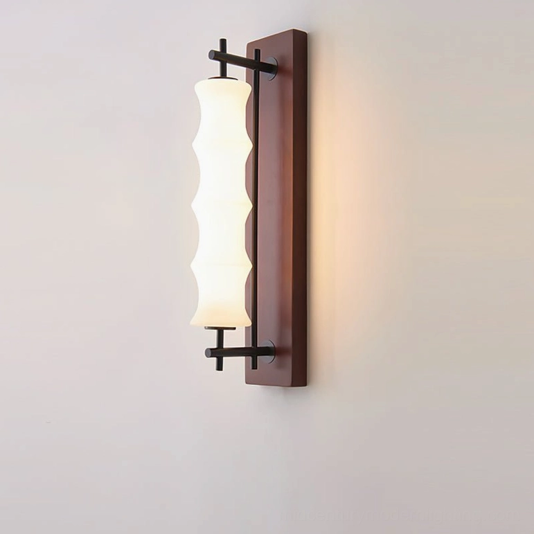 Nesta wall sconce close-up detail, dark finish with brushed metal brackets and wavy textured glass shade