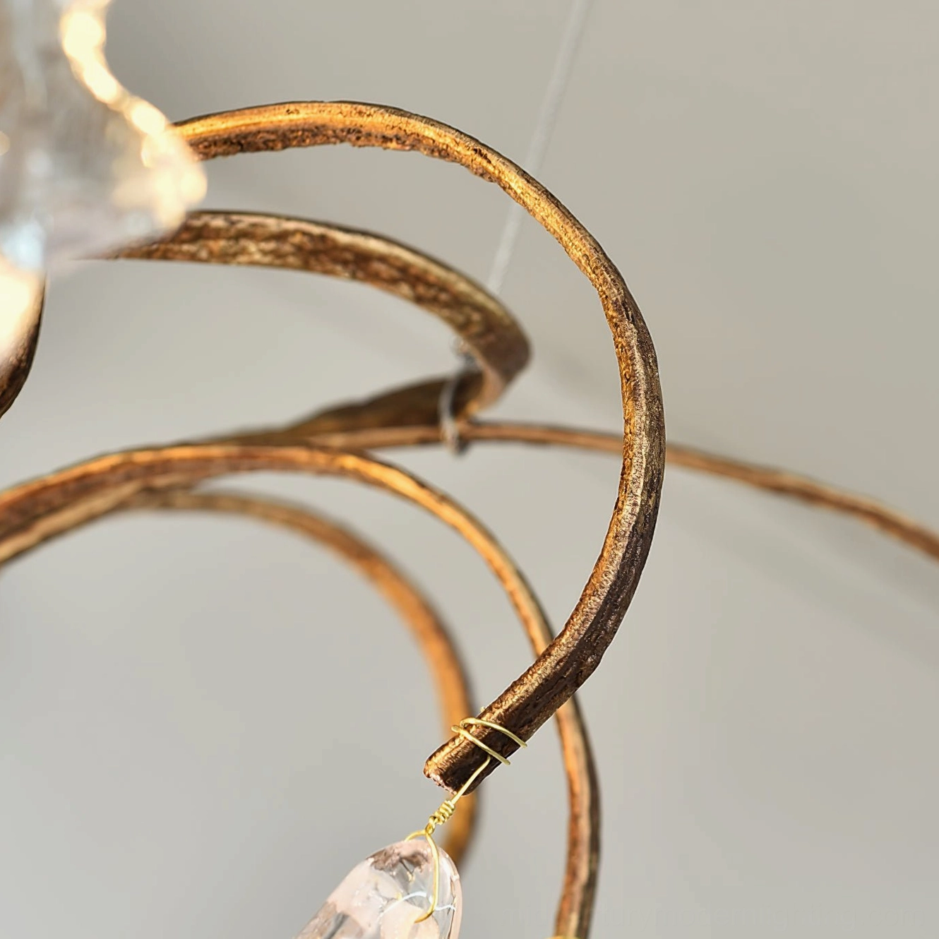 Niagara Chandelier artistic angle showing flowing brass curves and translucent glass elements
