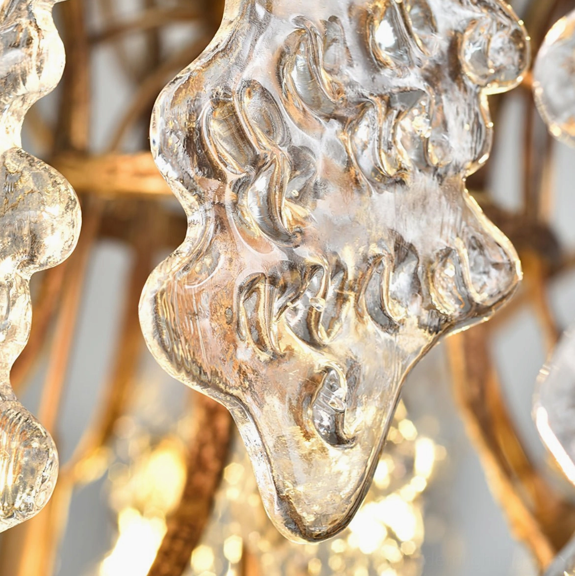 Close-up macro photography of Niagara Chandelier glass texture and brass-gold metalwork craftsmanship