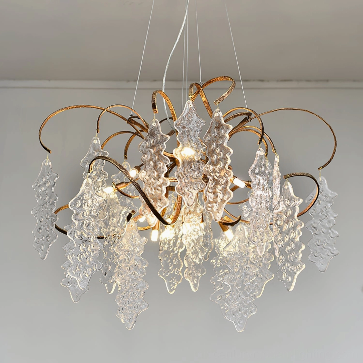 Niagara Round Chandelier in minimalist interior space showing three-quarter view with organic glass elements