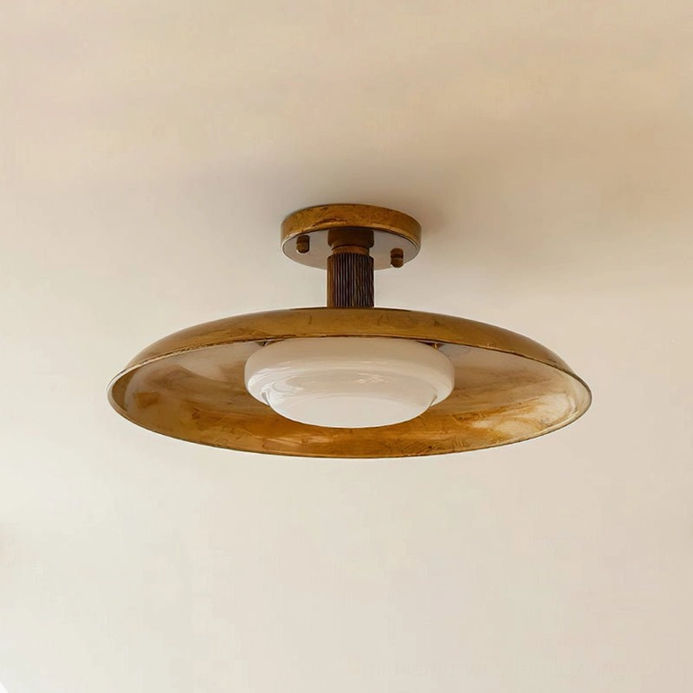 Nickel finish pot-lid ceiling light mounted and illuminated in contemporary interior room setting