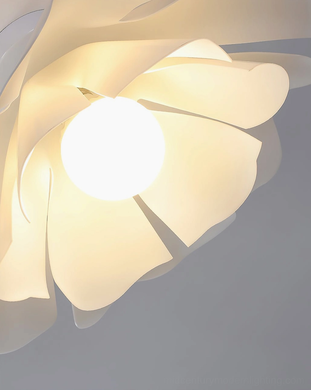 Close-up macro view of Nightbloom frosted acrylic petal shade with glowing round bulb detail