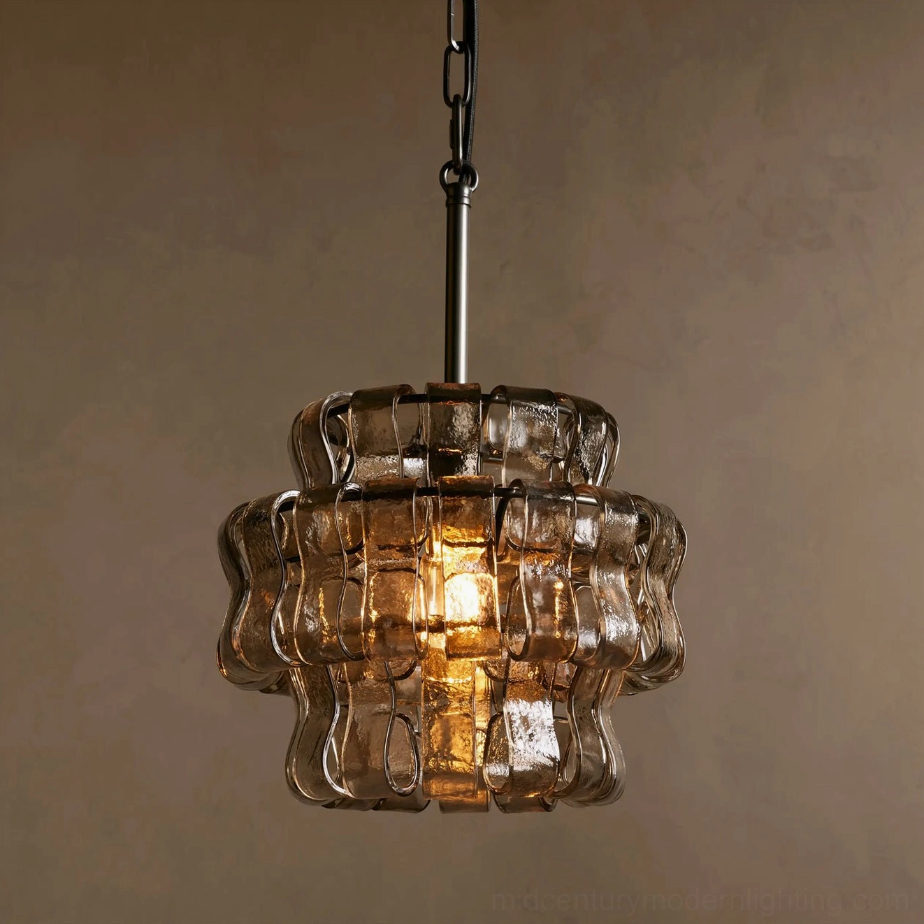 Nirsa pendant light with smoky rippled glass emitting intense warm lighting ambiance