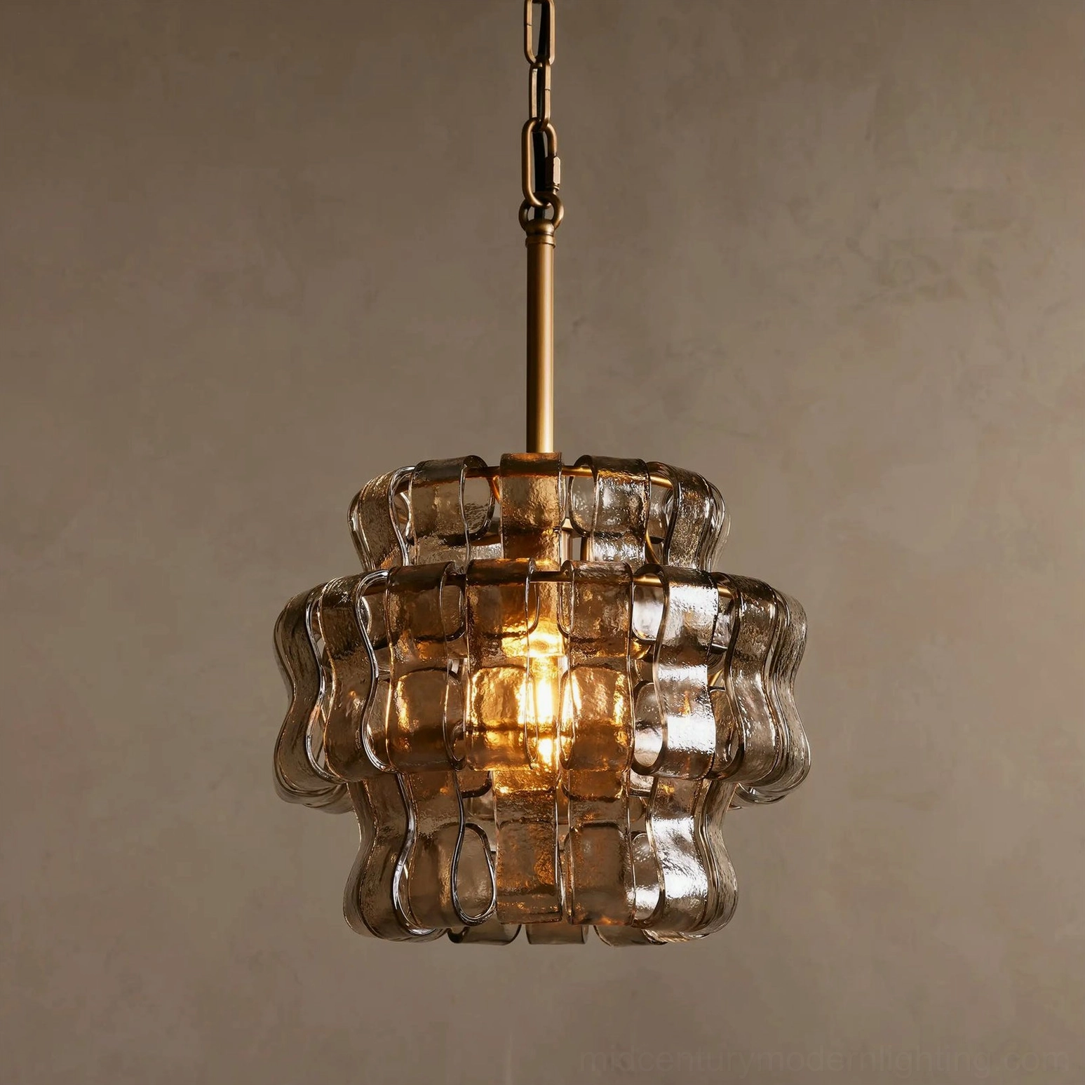 Lit Nirsa smoky gray pendant casting warm ambient light through textured glass layers