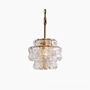 Nirsa wave pendant light with cascading textured glass panels and brass hardware, frontal studio view