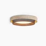 Nolan modern travertine ceiling light with perforated metal accent ring front view on white background