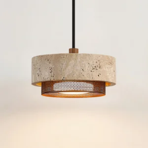 Close-up detail of Nolan pendant light showing porous travertine surface, warm beige veining, and perforated bronze trim ring