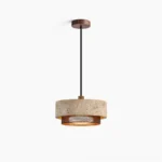 Nolan travertine pendant light with unfinished stone shade and bronze metal trim, front studio view showcasing natural pitting and geological texture