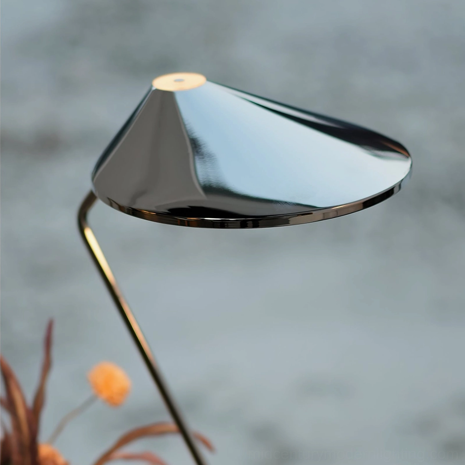 Close-up polished chrome cone lamp shade reflective metal finish detail