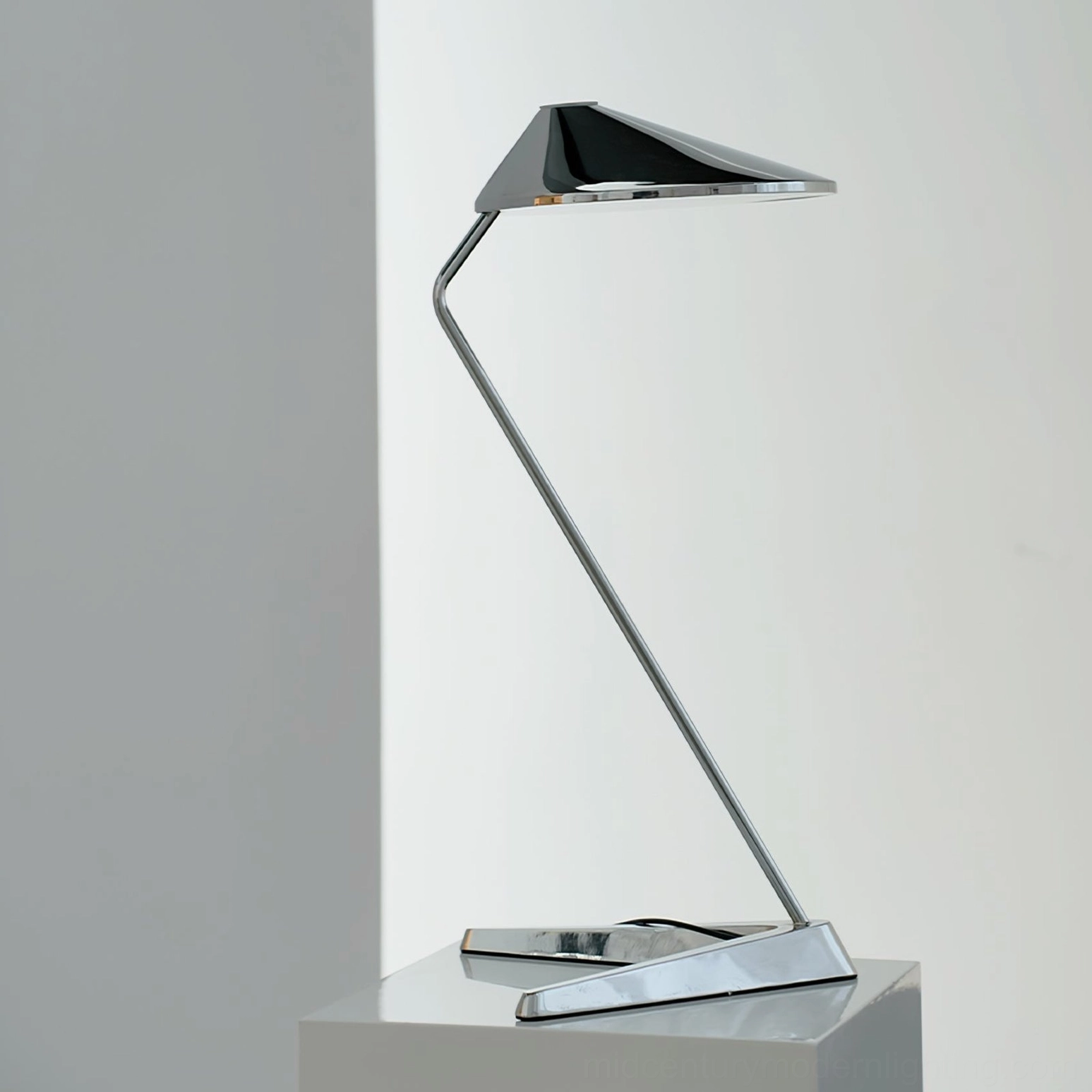 Chrome angular desk lamp side profile minimalist studio display