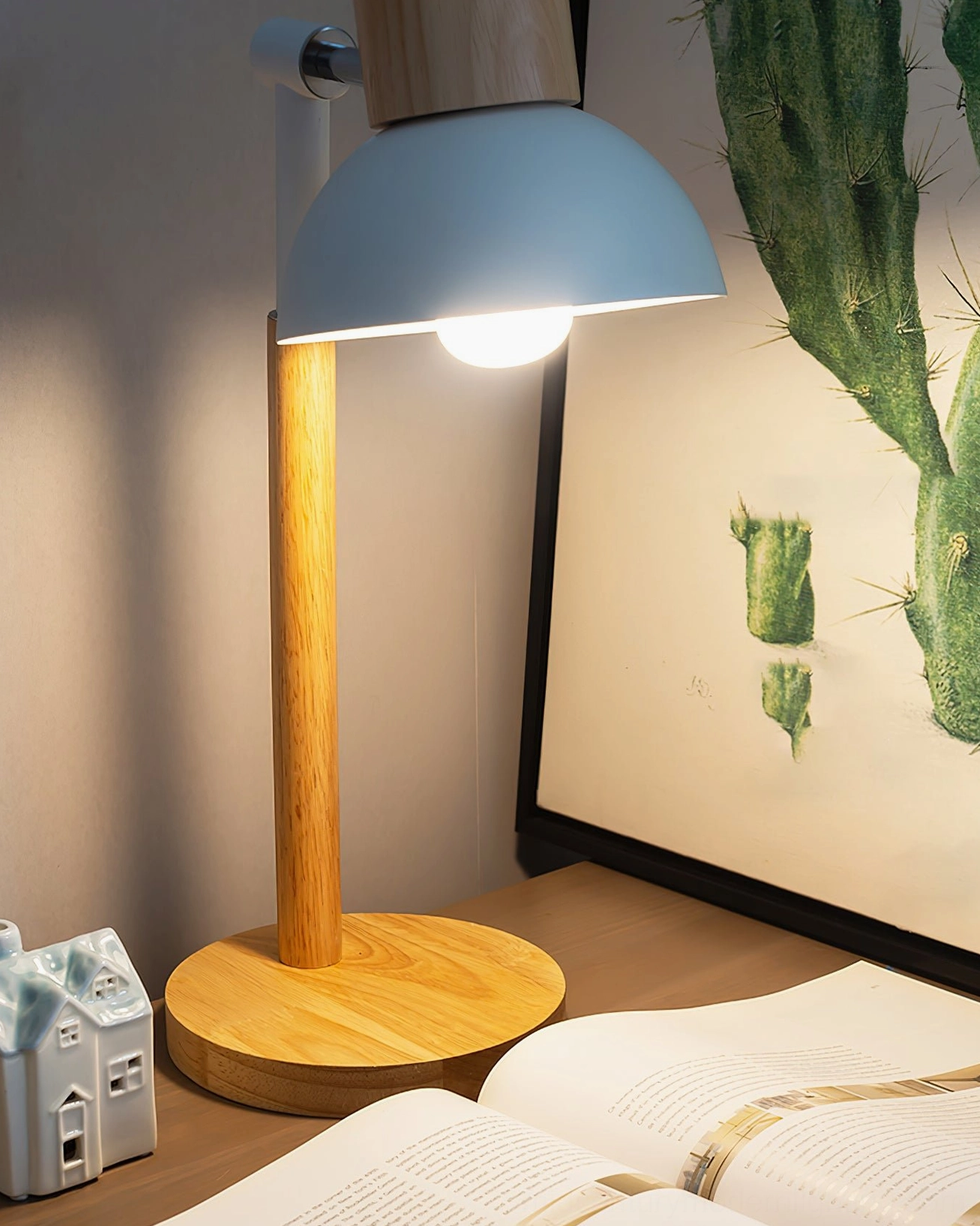 Scandinavian desk lamp with bird ornament and wood base detail shot for product showcase