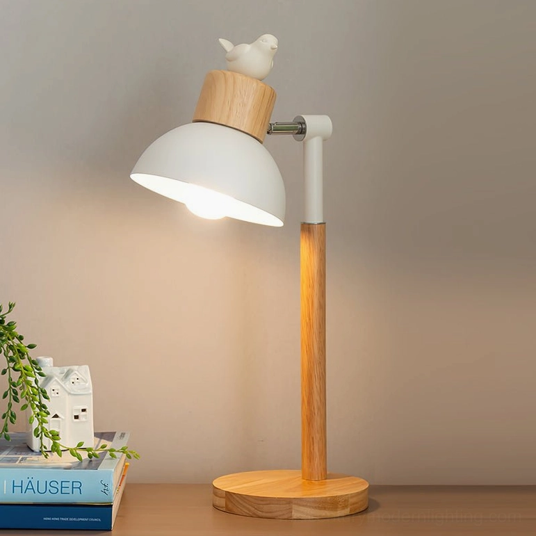 Nordic bird table lamp illuminated on home desktop with decorative ornaments and warm ambient lighting