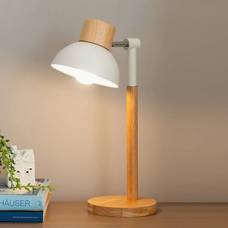 Scandinavian table lamp with adjustable arm lighting warm glow on home desktop with books and plant decor