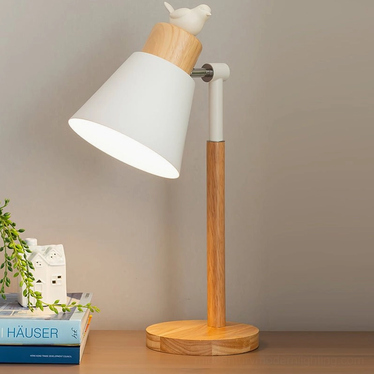 Nordic bird table lamp rear view showing power cord on wooden desktop with warm ambient lighting