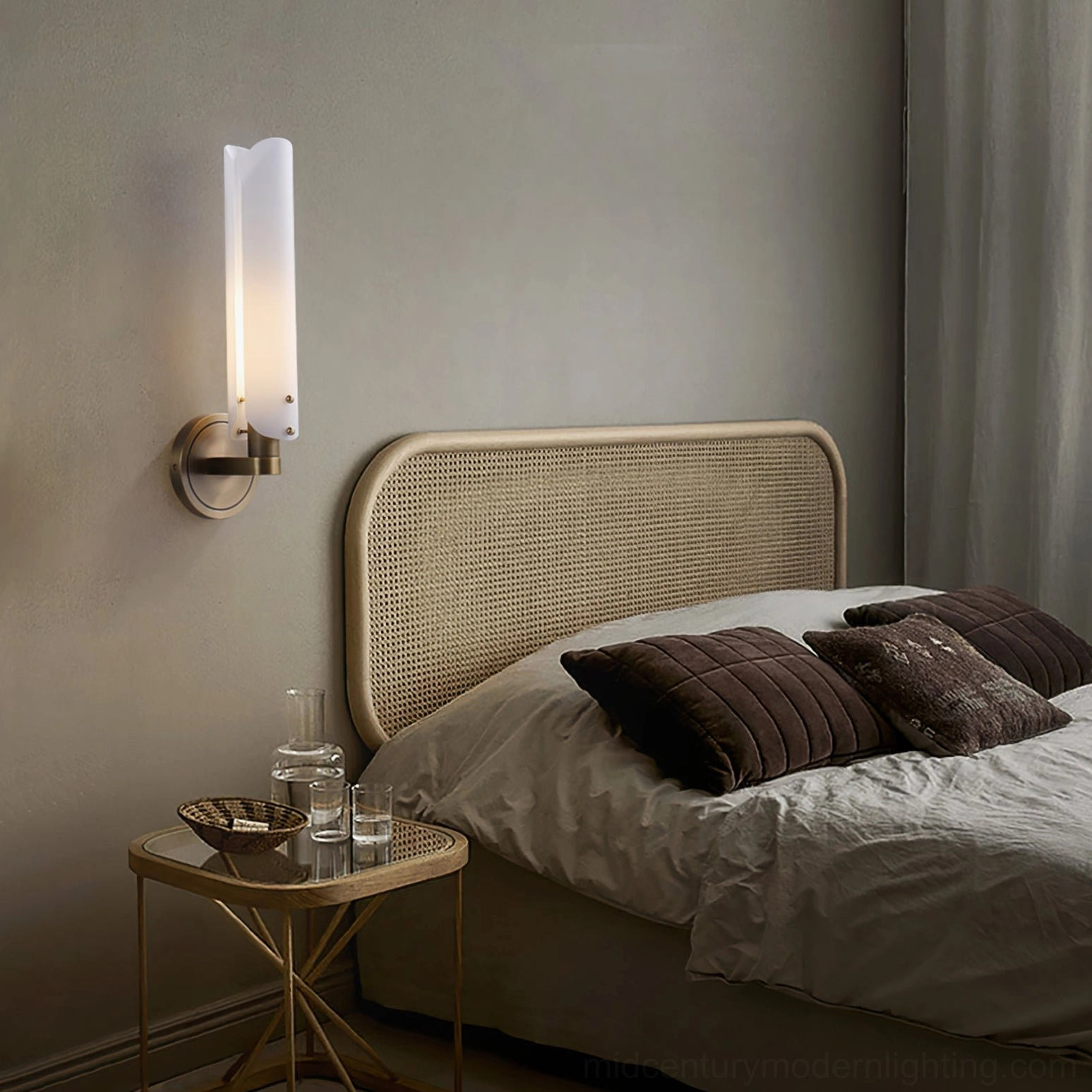 Single compact brass wall sconce with cylindrical frosted glass shade for bedroom bedside accent