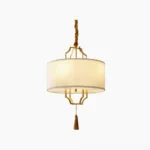 Norwell brass chandelier with dual circular backplates and white linen shades, front view