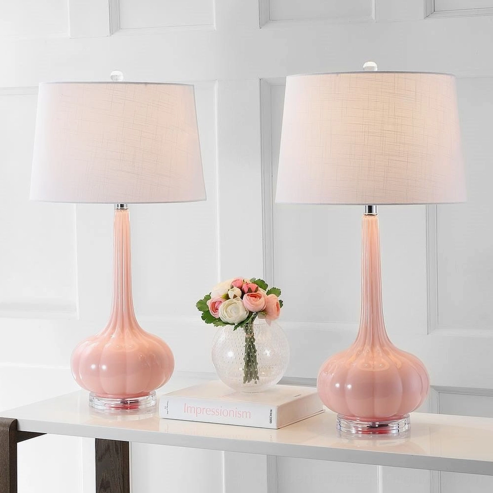 Matching pair of pink ceramic gourd glass table lamps on home console table decorative accents