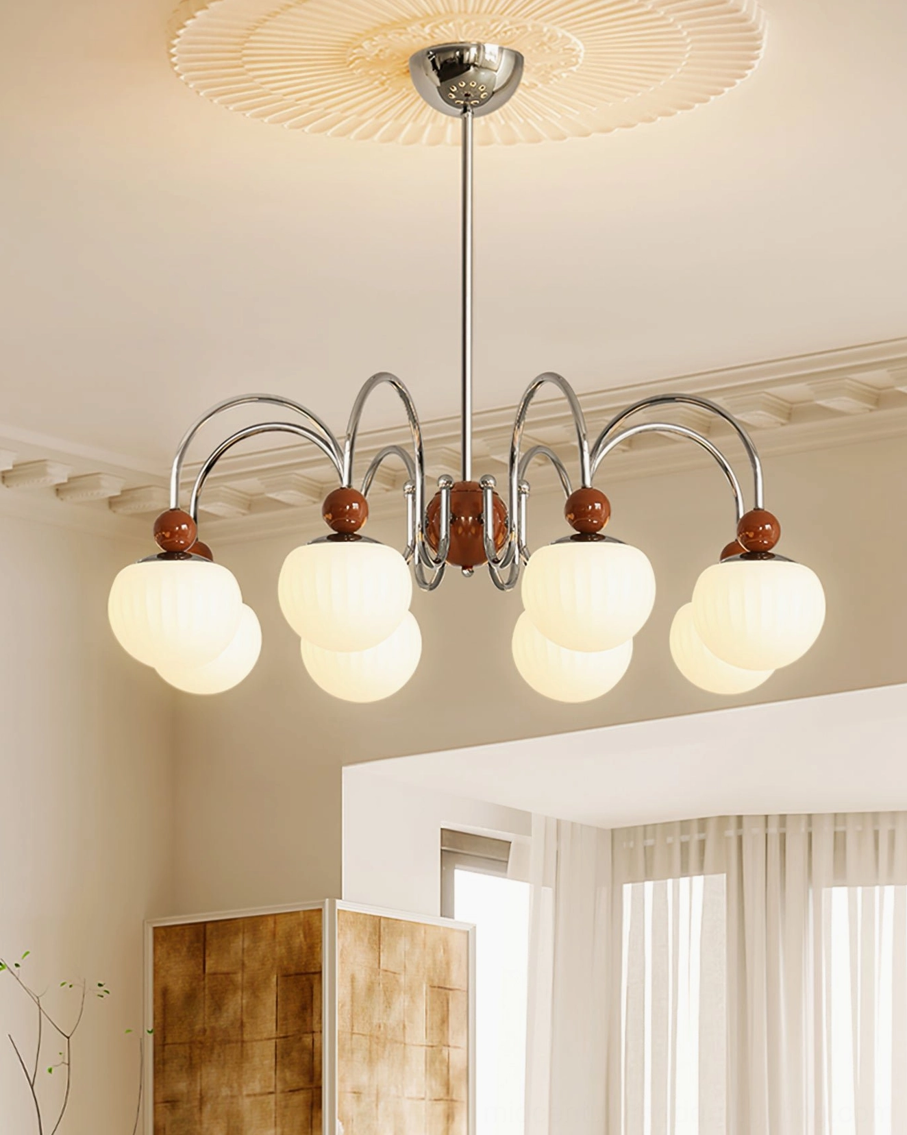 Notti mid-century chandelier styled in modern residential room with brown metal accents and warm illuminated lamp shades