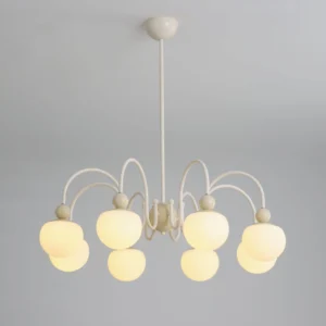 Lit Notti mid-century chandelier illuminated overhead view showing warm glowing frosted glass shades and cream metal frame