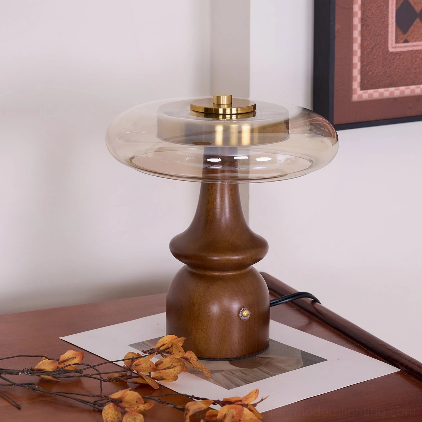 Nova table lamp three-quarter view displaying wood grain and brass accents on vintage wooden bedside table with botanical decor