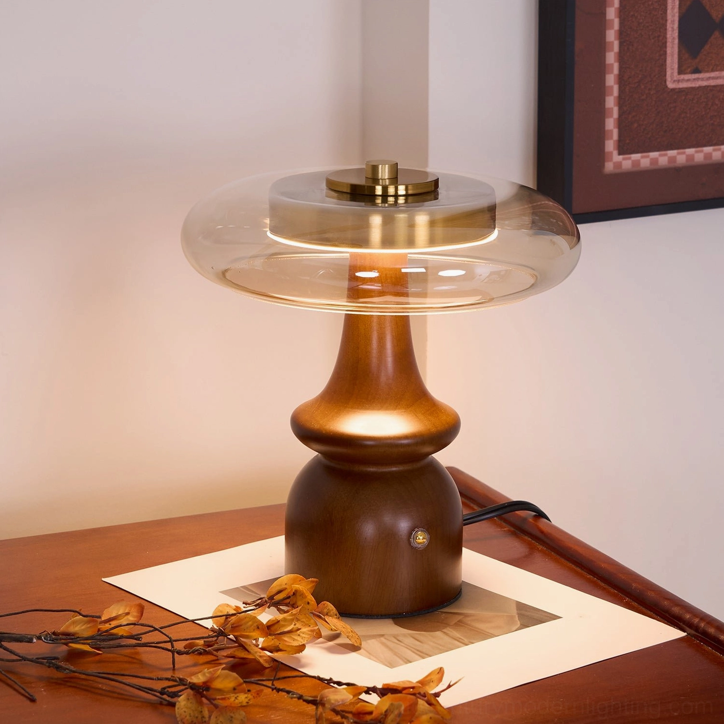 Nova mid-century modern table lamp left three-quarter angle showing walnut finish base and exposed power cord on wooden furniture