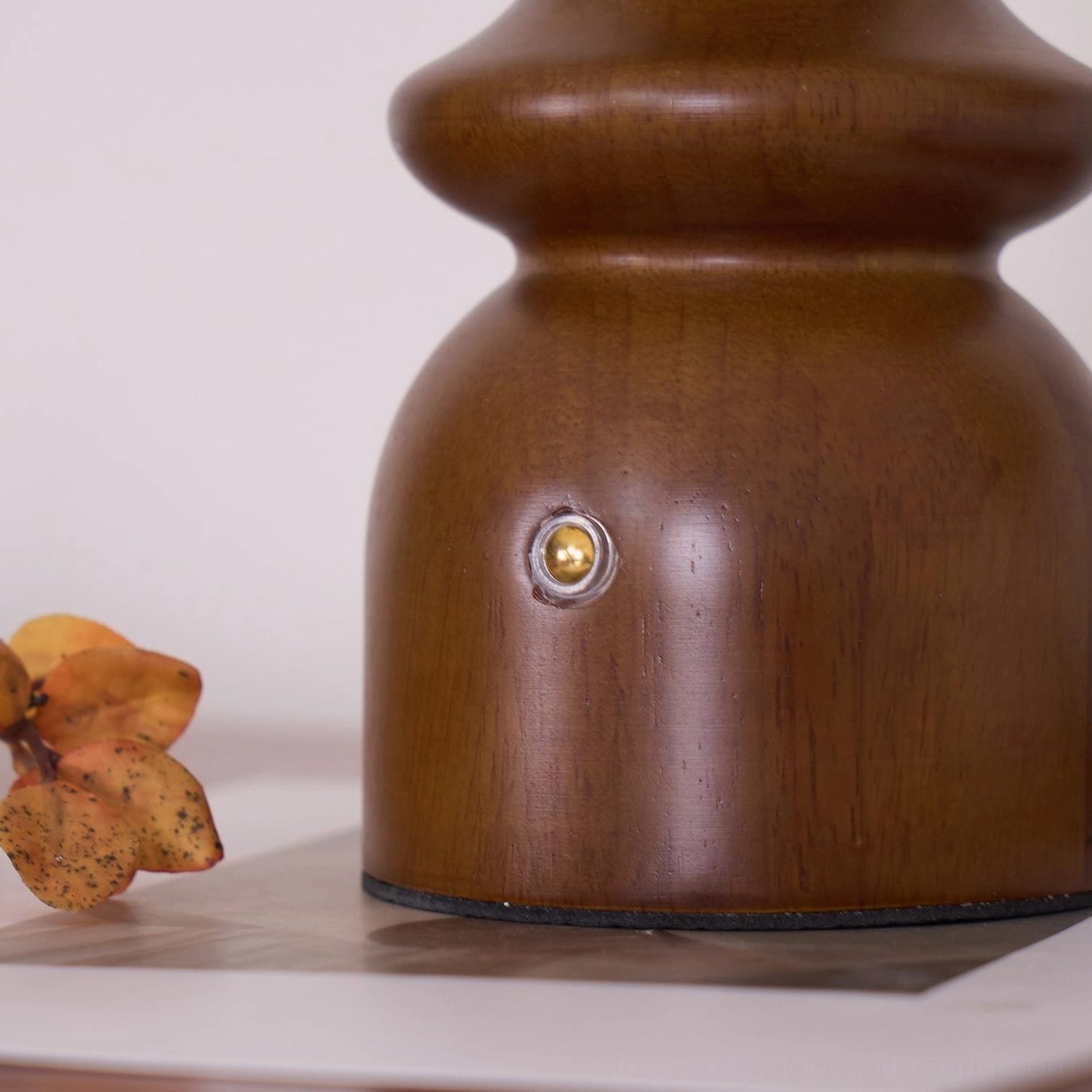 Nova mid-century modern table lamp base detail showing hand-finished walnut wood grain and stable sculptural form