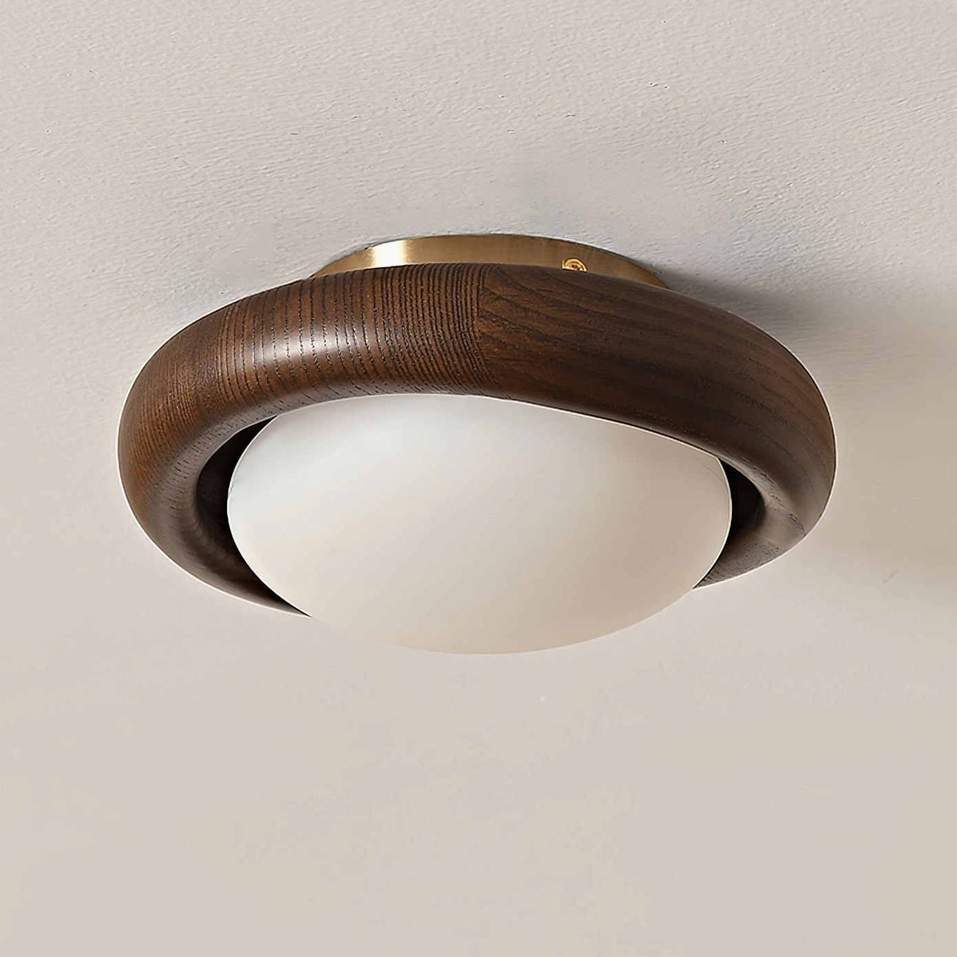 Novi flush mount ceiling lamp installed overhead showing warm LED glow and natural wood grain detail