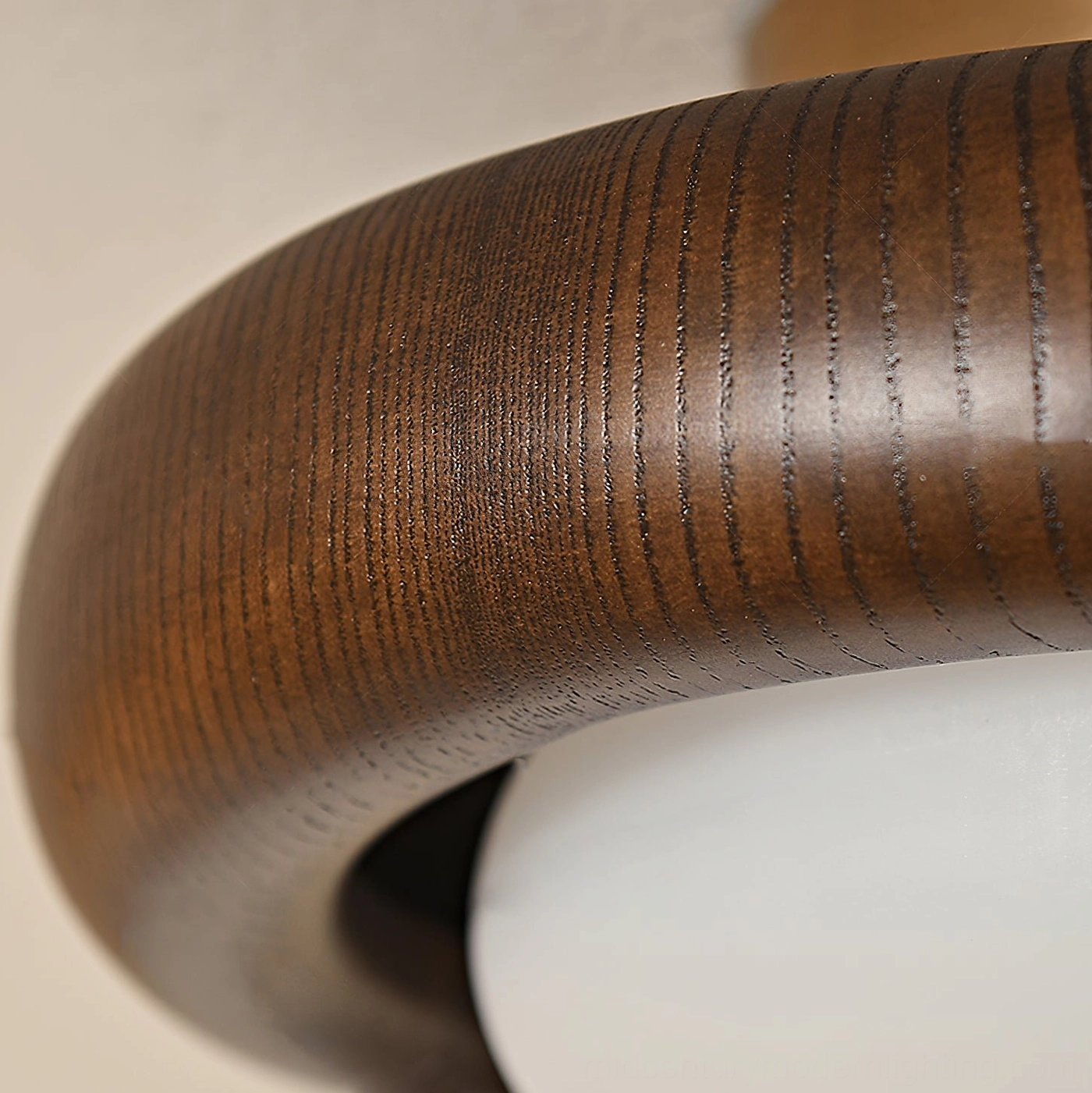 Close-up detail of Novi ceiling light wooden frame showing natural wood grain texture and circular design