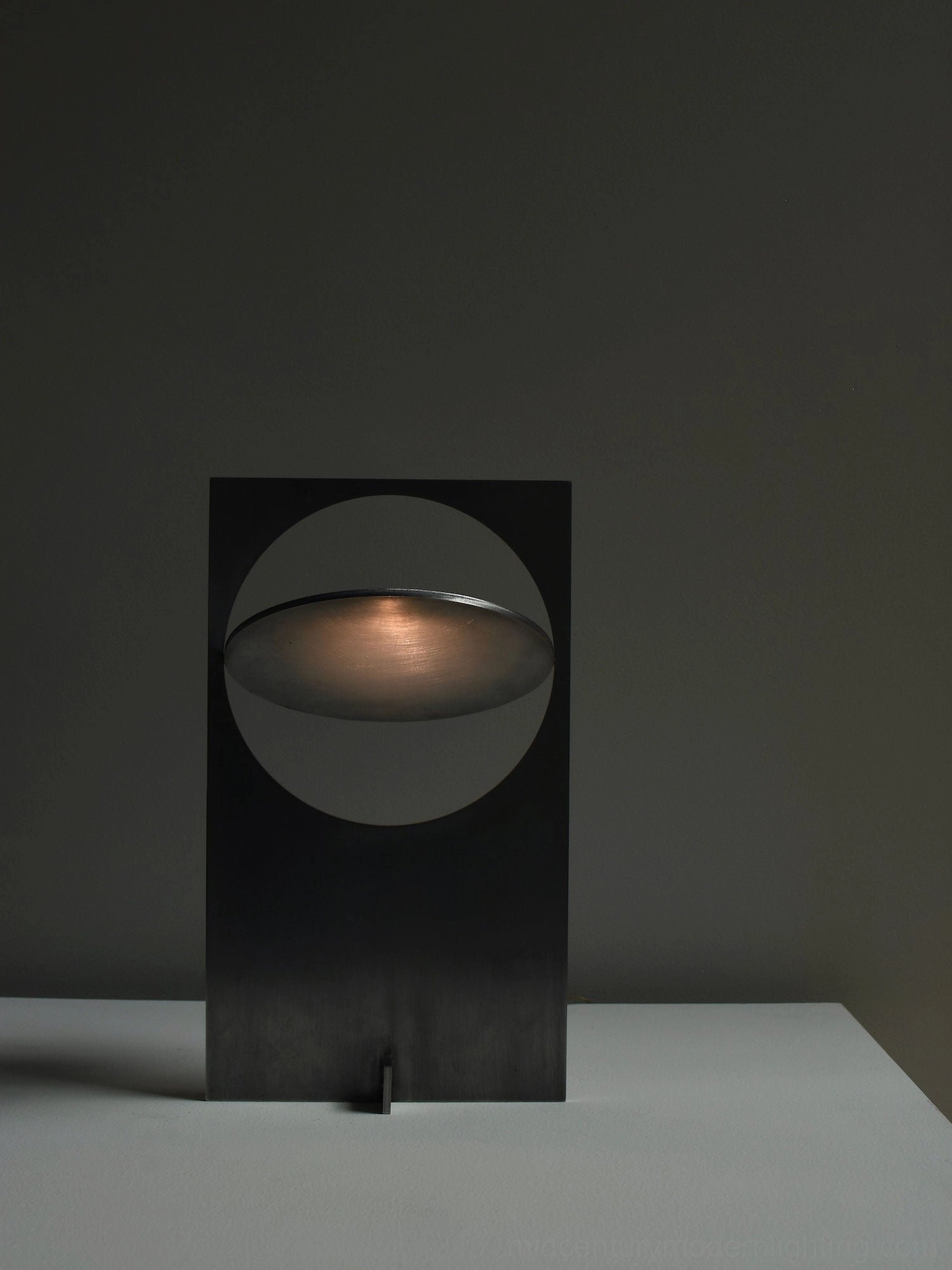 OBJ 01 brass gold minimalist table lamp sculptural view, metal finish details, geometric design form, product photography lighting