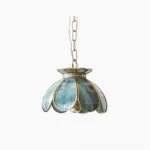 Odette lotus glass pendant light with handcrafted scalloped clear glass petals and brass filigree collar, frontal view on white background